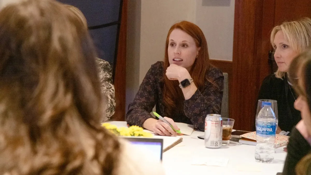 Core4 attendees listening at table.