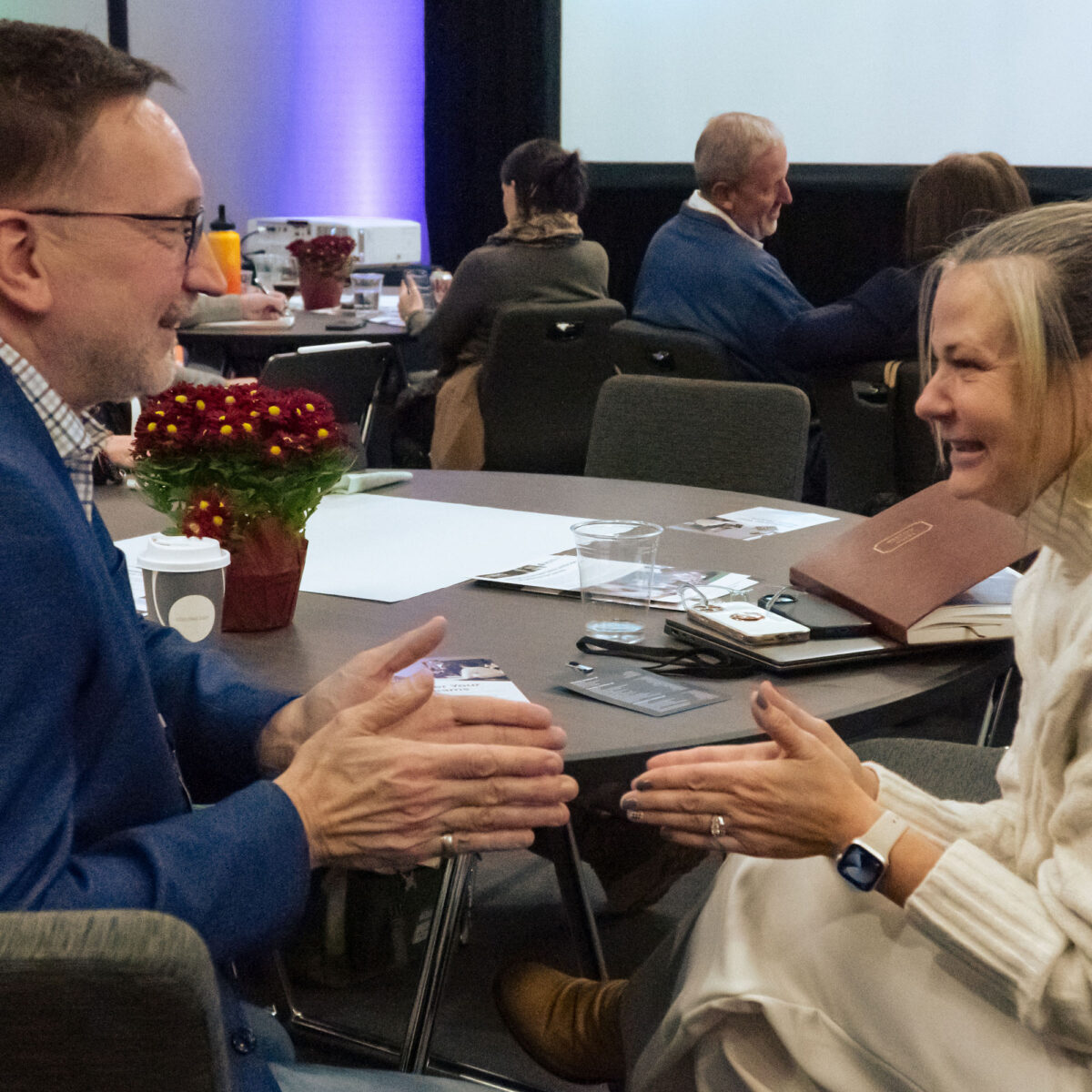 Core4 attendees interacting at table.